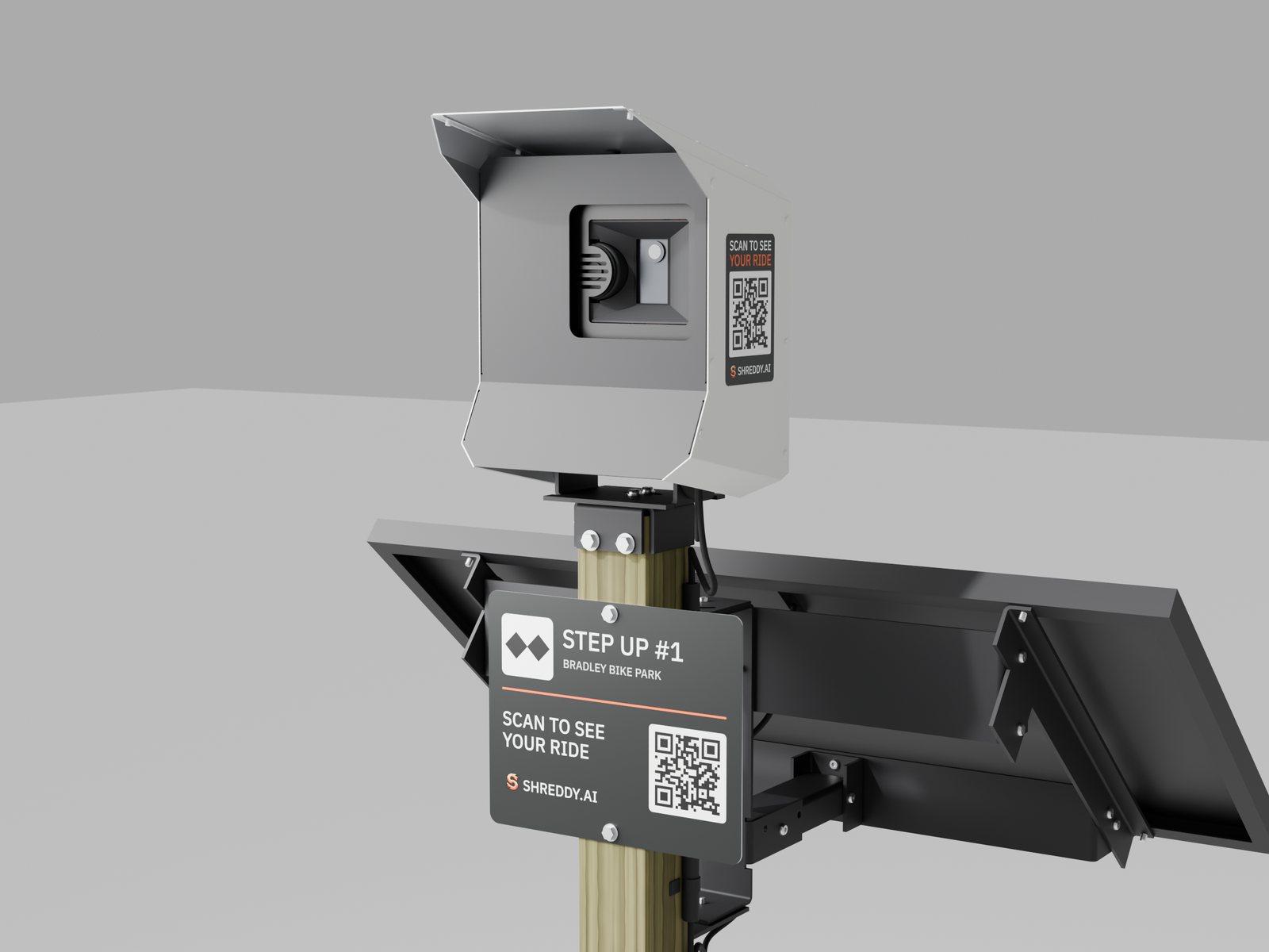 The Shreddy post station: a white camera box on a 4x4 post, the trail sign with its QR code, and the solar panel behind